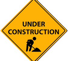 A yellow sign with the words under construction.