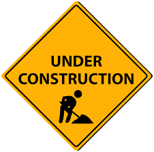 A yellow sign with the words under construction.