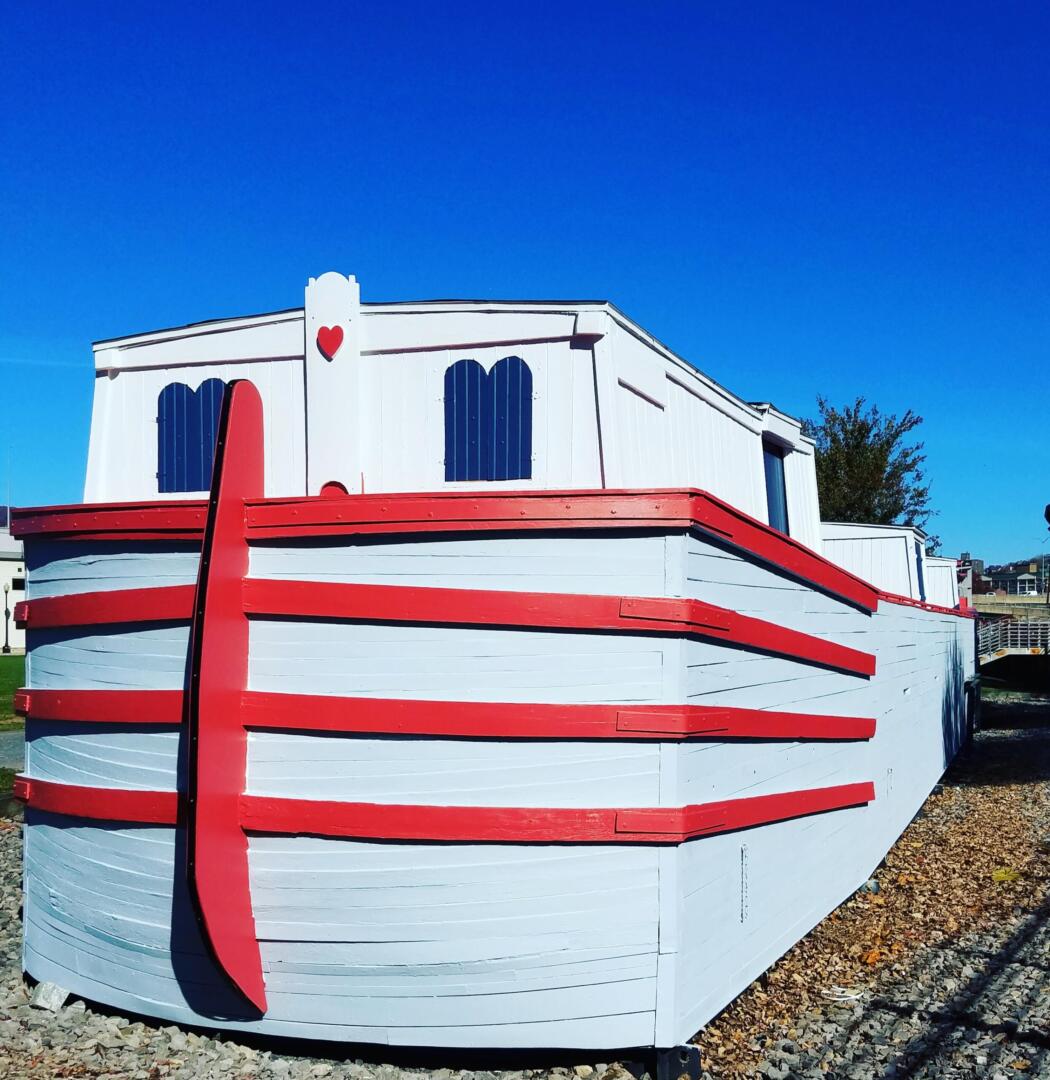 Red and white replica canal boat.